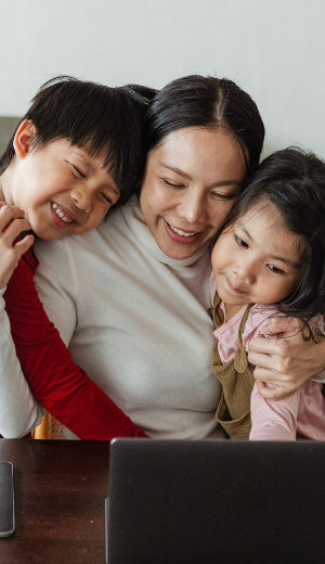Employees are happy to work from home. They prefer the choice of hybrid working. A happy mother with her two kids.